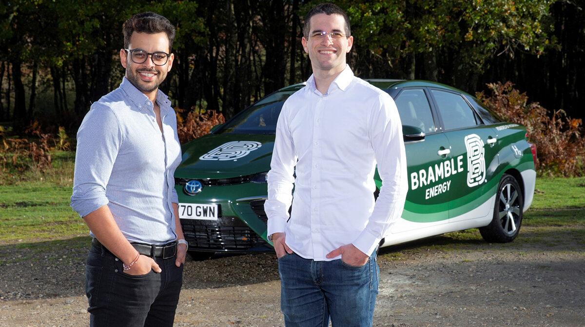 Dr Vidal Bharath and Dr Tom Mason standing in front of a car with the Bramble Energy Logo
